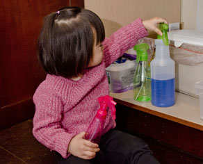 Child playing with cleaners